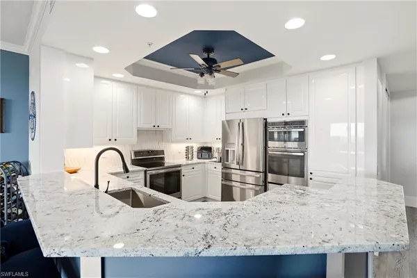 a kitchen with granite countertop a table and chairs