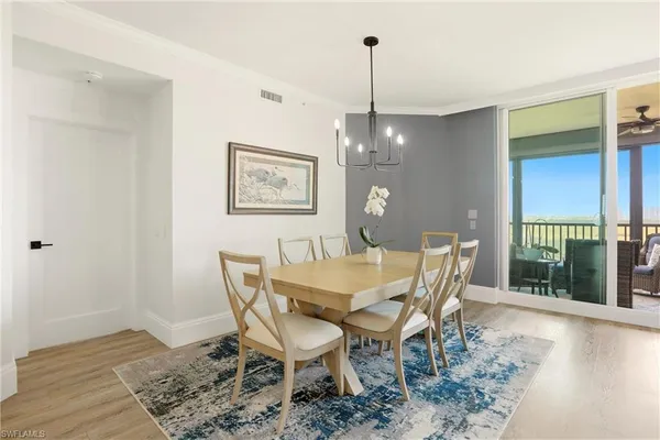 a view of a dining room with furniture wooden floor and chandelier