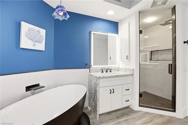 a bathroom with a sink a mirror and a shower