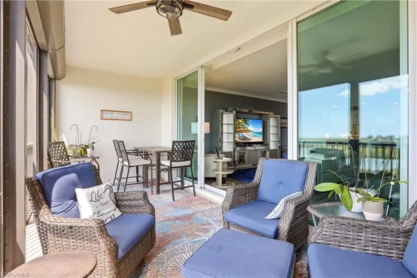 a living room with furniture and a floor to ceiling window