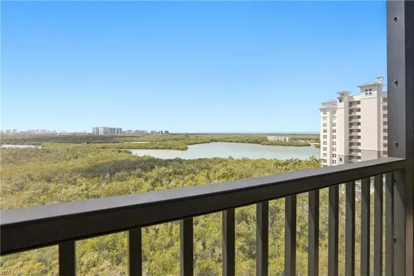a view of city and ocean from a balcony