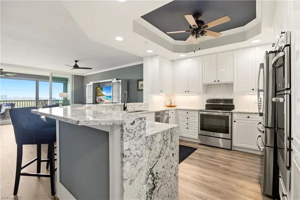 a kitchen with stainless steel appliances granite countertop a sink stove and refrigerator