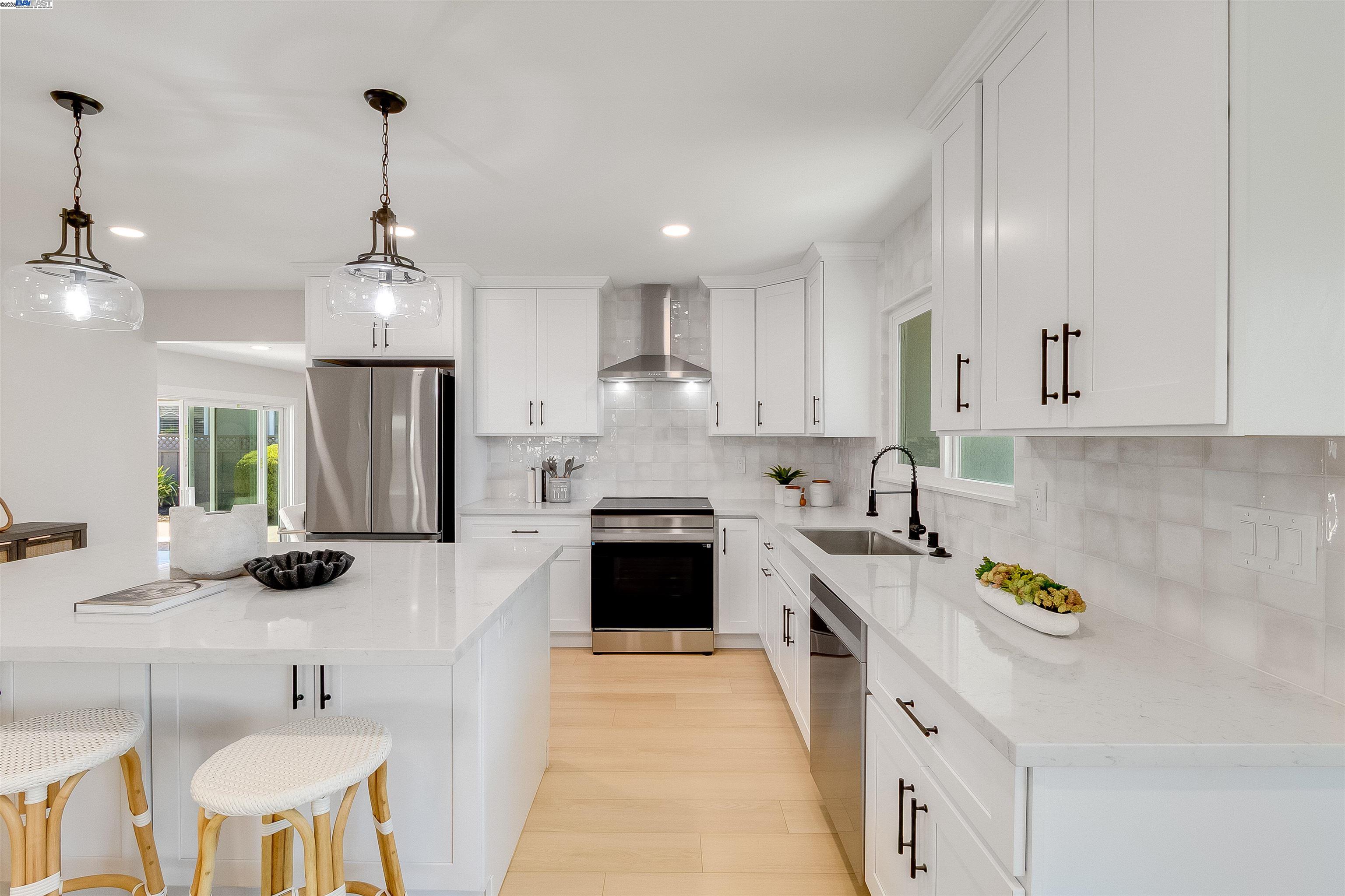 736 Adams Avenue Livermore, CA 94550 - Photo 16 of 52 a kitchen with stainless steel appliances a stove sink and cabinets