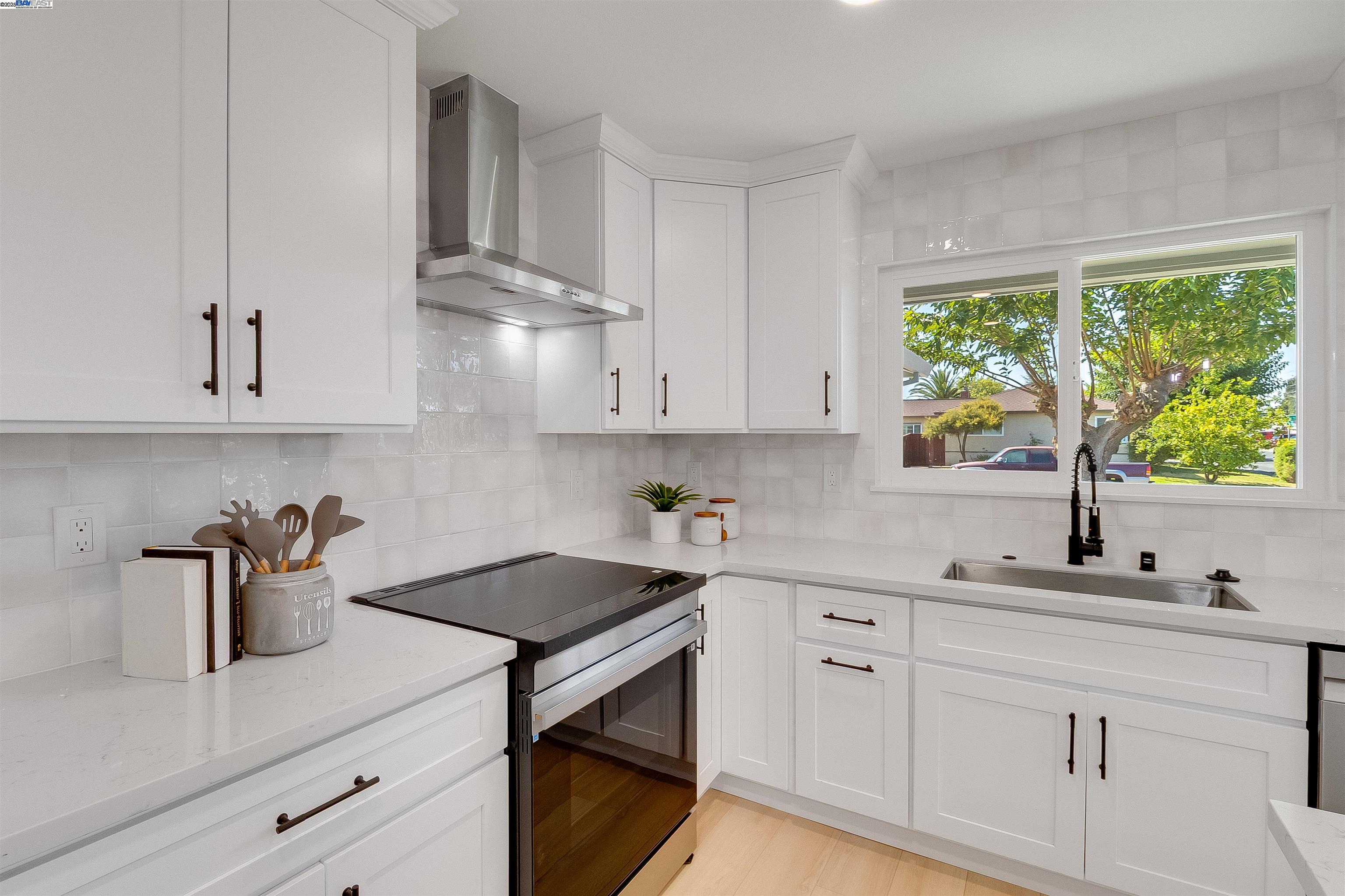 736 Adams Avenue Livermore, CA 94550 - Photo 19 of 52 a kitchen with white cabinets a window and a sink