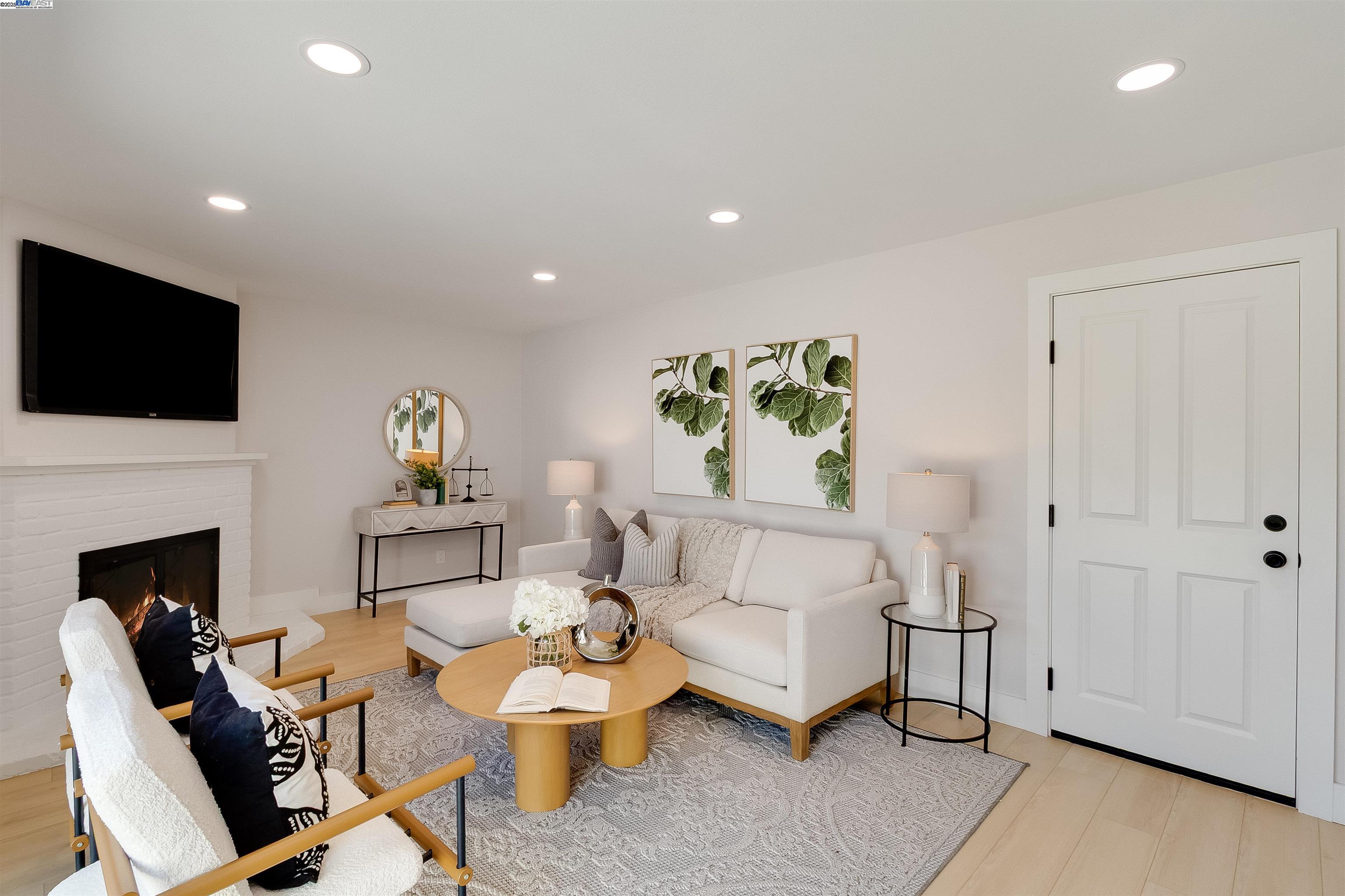 736 Adams Avenue Livermore, CA 94550 - Photo 23 of 52 a living room with furniture a fireplace and a flat screen tv