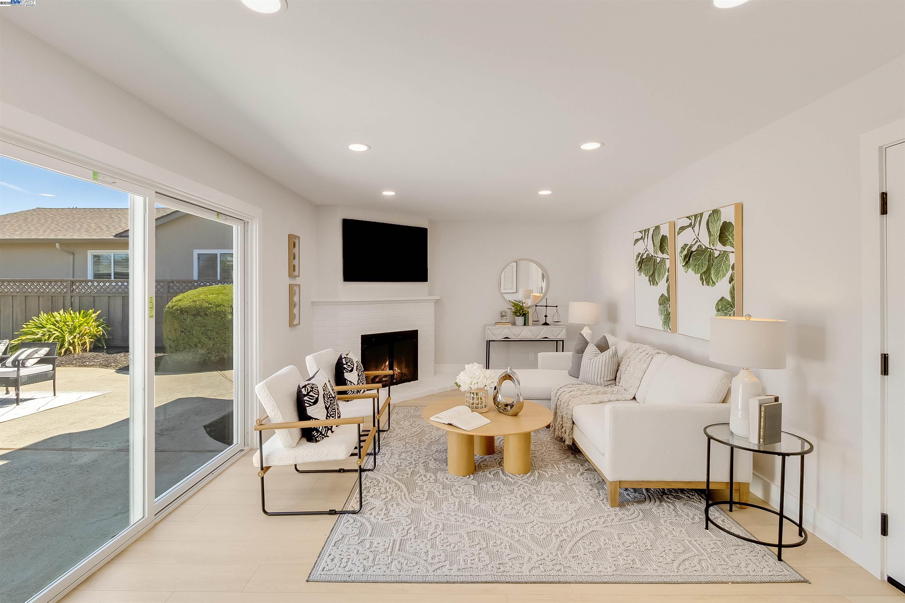 736 Adams Avenue Livermore, CA 94550 - Photo 25 of 52 a living room with furniture a fireplace and a flat screen tv