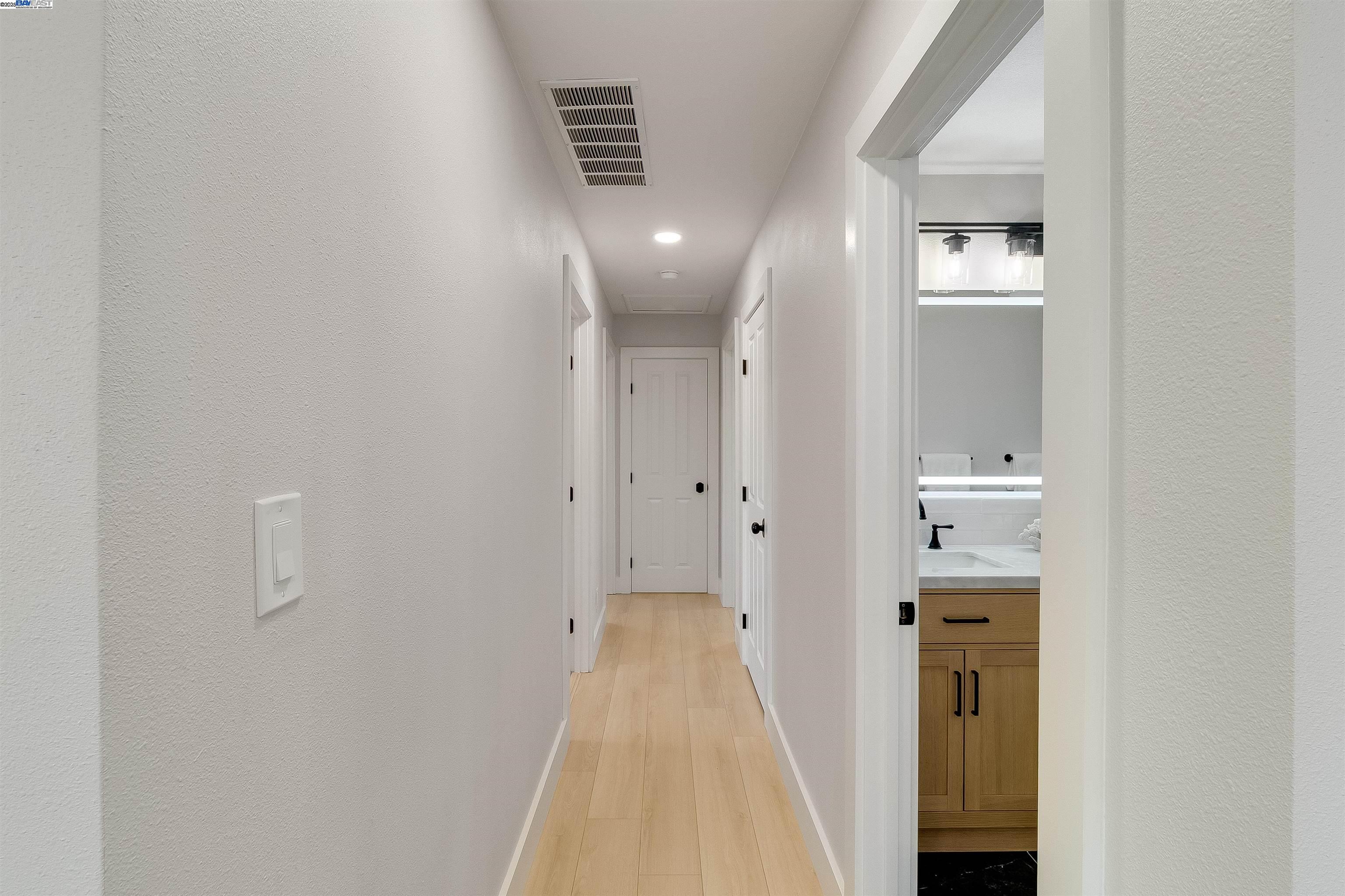 736 Adams Avenue Livermore, CA 94550 - Photo 27 of 52 a view of a hallway with wooden floor