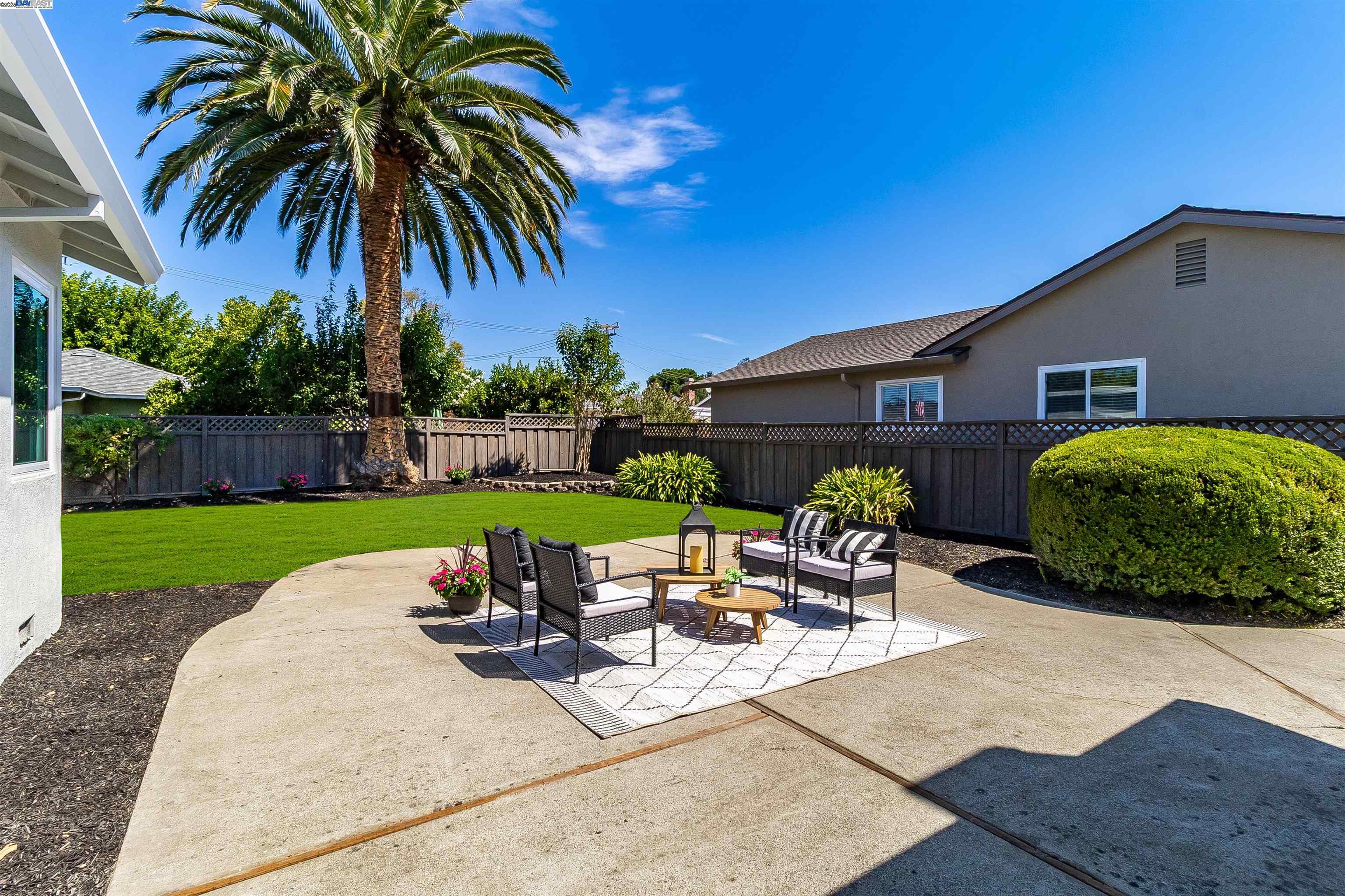 736 Adams Avenue Livermore, CA 94550 - Photo 40 of 52 a view of a backyard with table and chairs with plants and wooden fence