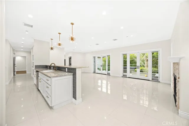 a large white kitchen with a large window