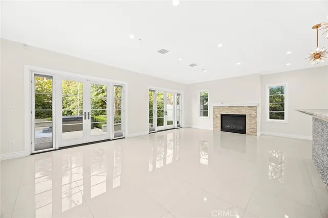 a view of an empty room with a fireplace and a window