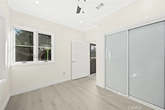 an empty room with windows and closet