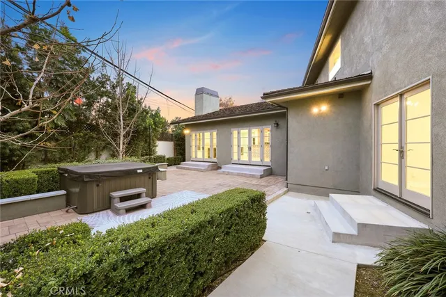 a view of a patio with a table and chairs and potted plants