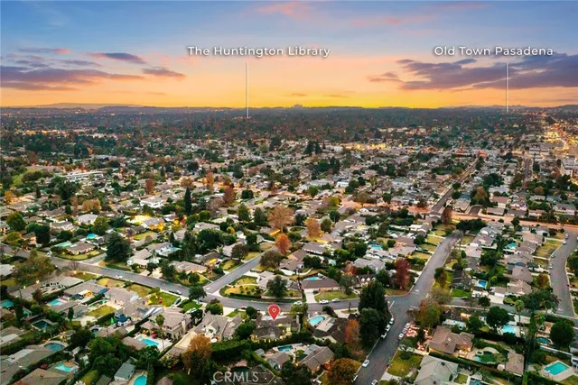 an aerial view of a house with a yard and potted plants