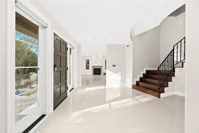 a view of entryway and hall with wooden floor