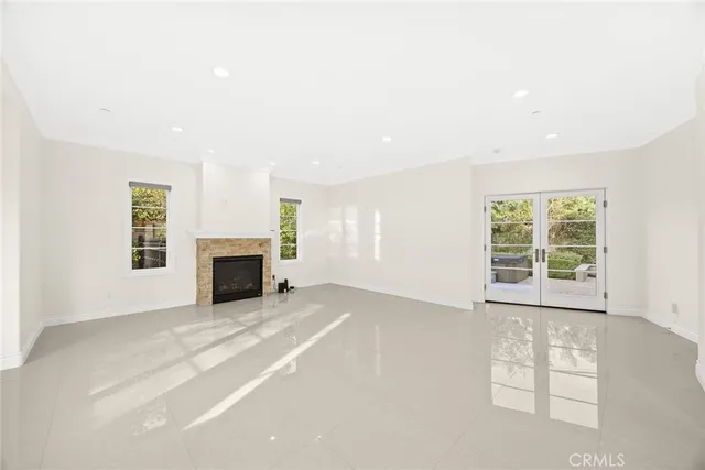 an empty room with furniture and a fireplace