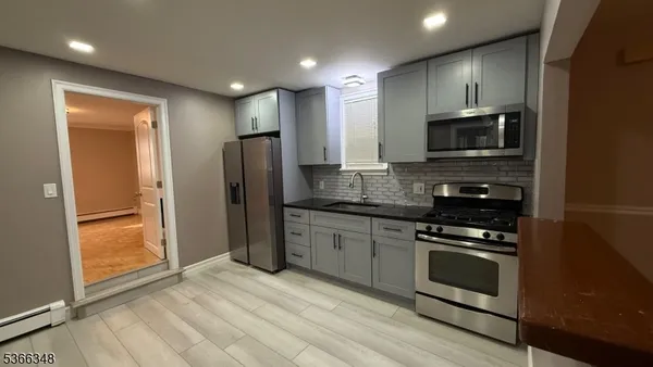 a kitchen with stainless steel appliances granite countertop a stove and a refrigerator