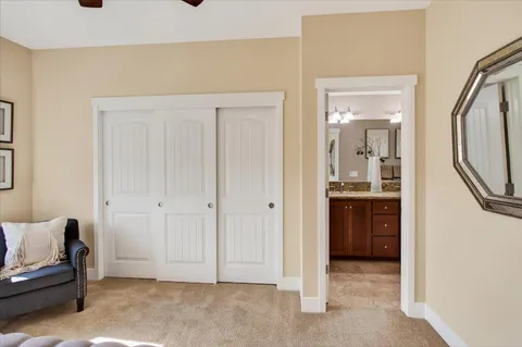 a large bed sitting in a bedroom next to a window