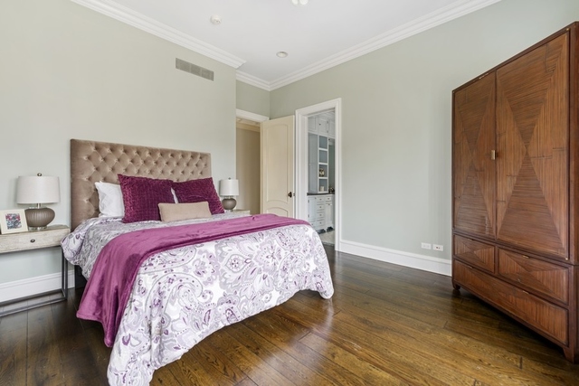 1746 West Surf Street Chicago, IL 60657 - Photo 27 of 37 a bedroom with a bed and wooden floor