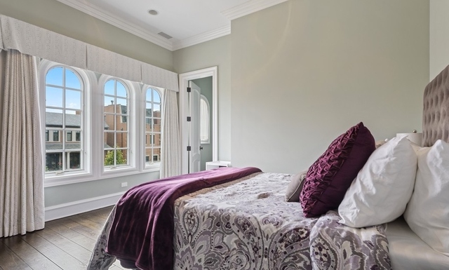 1746 West Surf Street Chicago, IL 60657 - Photo 28 of 37 a bed sitting in a bedroom next to a window