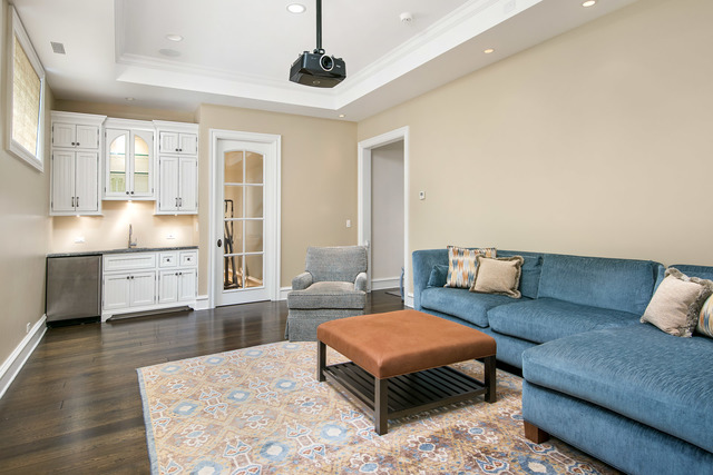 1746 West Surf Street Chicago, IL 60657 - Photo 33 of 37 a living room with furniture and a chandelier