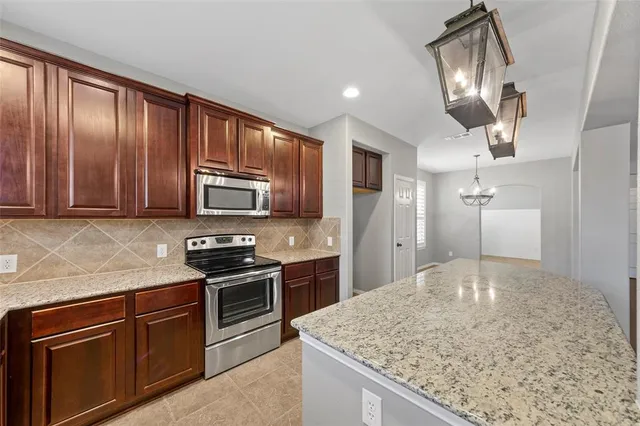 a kitchen with stainless steel appliances granite countertop a sink and stove