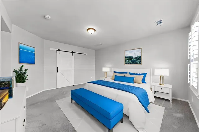 a bedroom with a bed and a potted plant