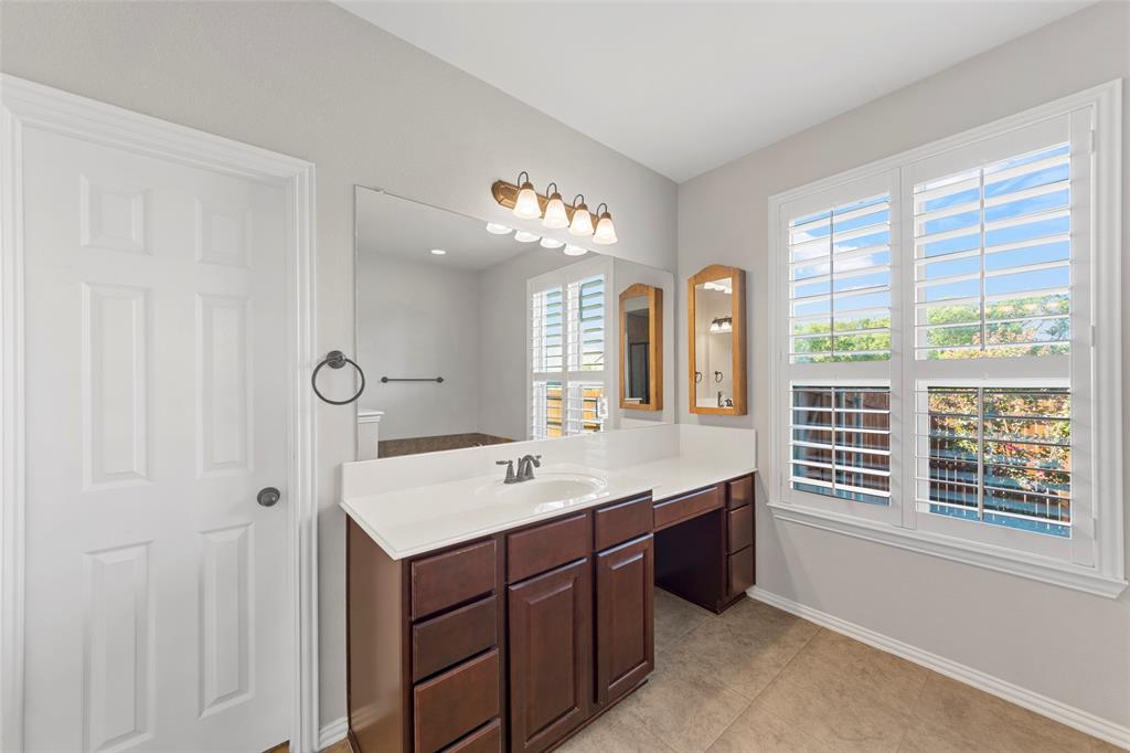 1901 Fair Parke Lane Wylie, TX 75098 - Photo 22 of 37 a spacious bathroom with a double vanity sink a mirror and a shower