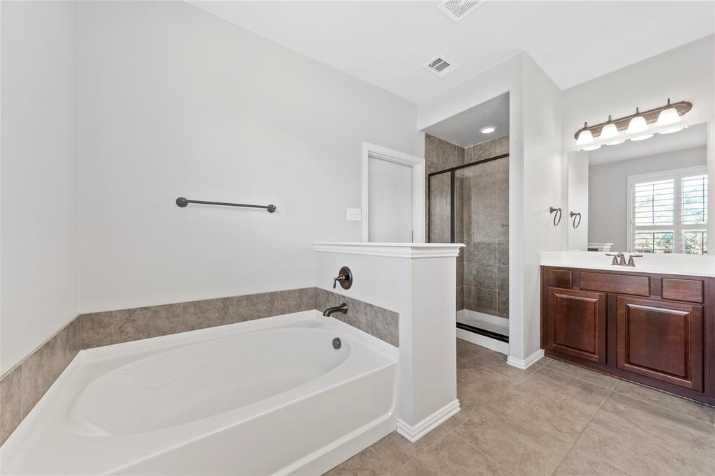 1901 Fair Parke Lane Wylie, TX 75098 - Photo 23 of 37 a bathroom with a bathtub and a double vanity sink
