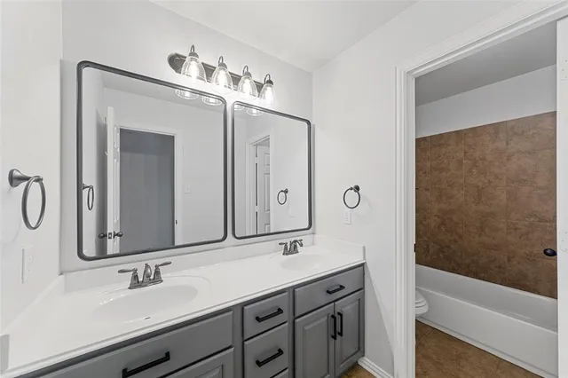 a bathroom with a double vanity sink double vanity and a mirror