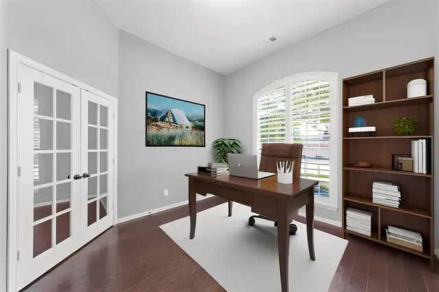 a view of a workspace with furniture and a bookshelf