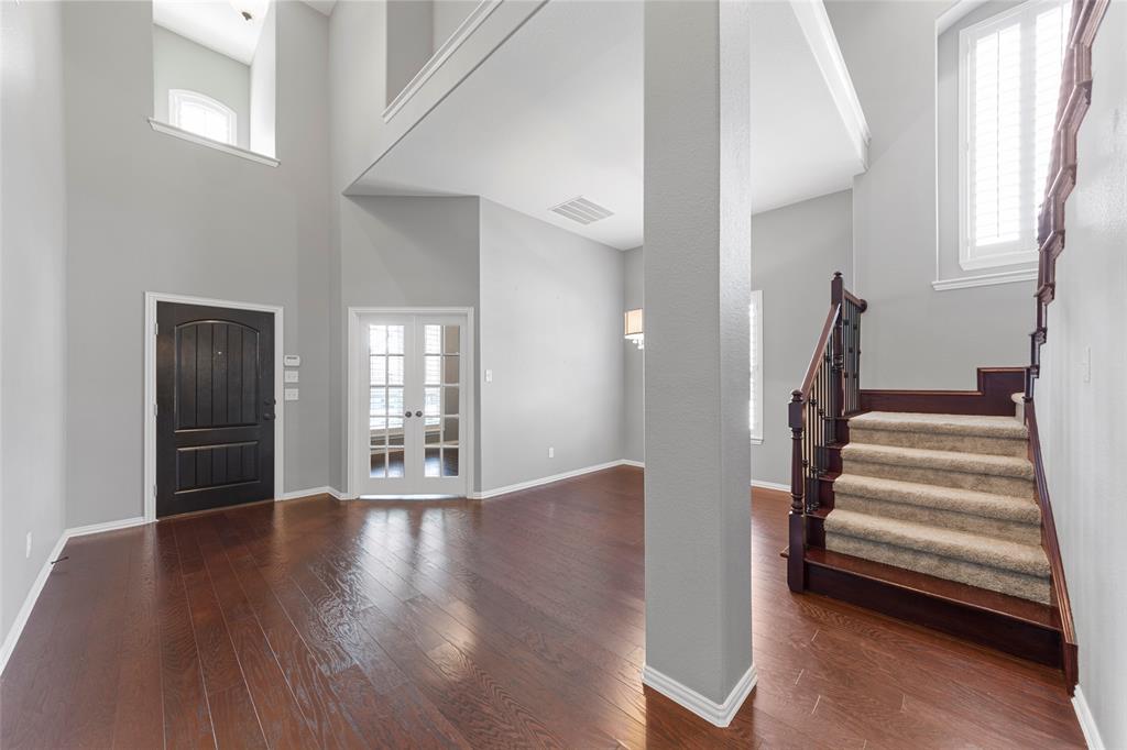 1901 Fair Parke Lane Wylie, TX 75098 - Photo 6 of 37 a view of an empty room with wooden floor and stairs