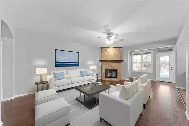 a living room with furniture a fireplace and a flat screen tv