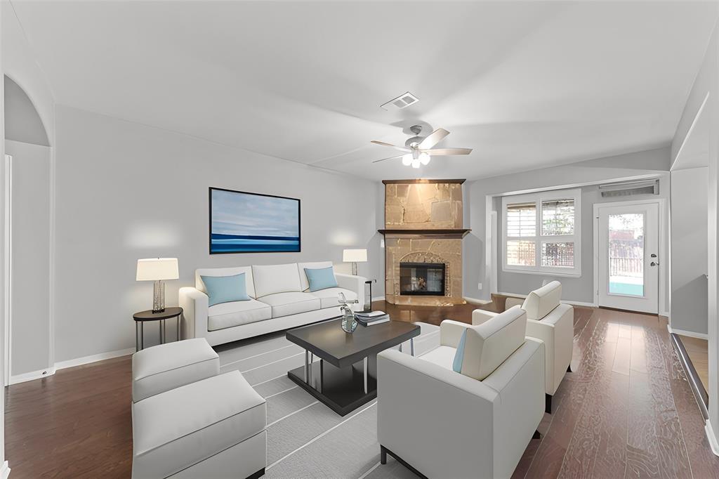 1901 Fair Parke Lane Wylie, TX 75098 - Photo 8 of 37 a living room with furniture a fireplace and a flat screen tv