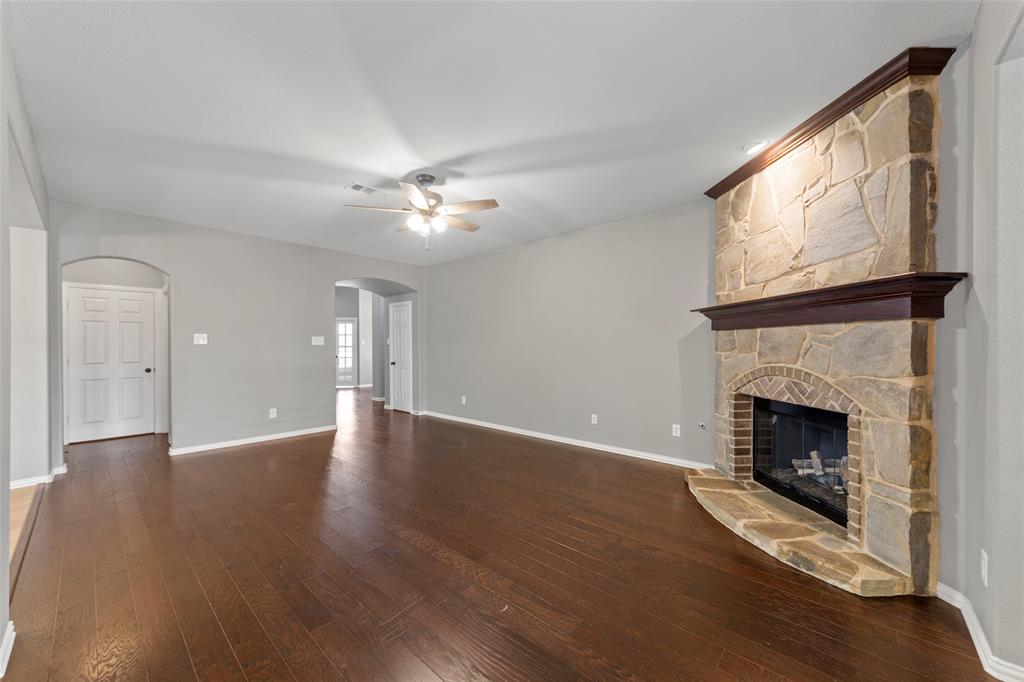 1901 Fair Parke Lane Wylie, TX 75098 - Photo 9 of 37 a view of an empty room with wooden floor fireplace and a window