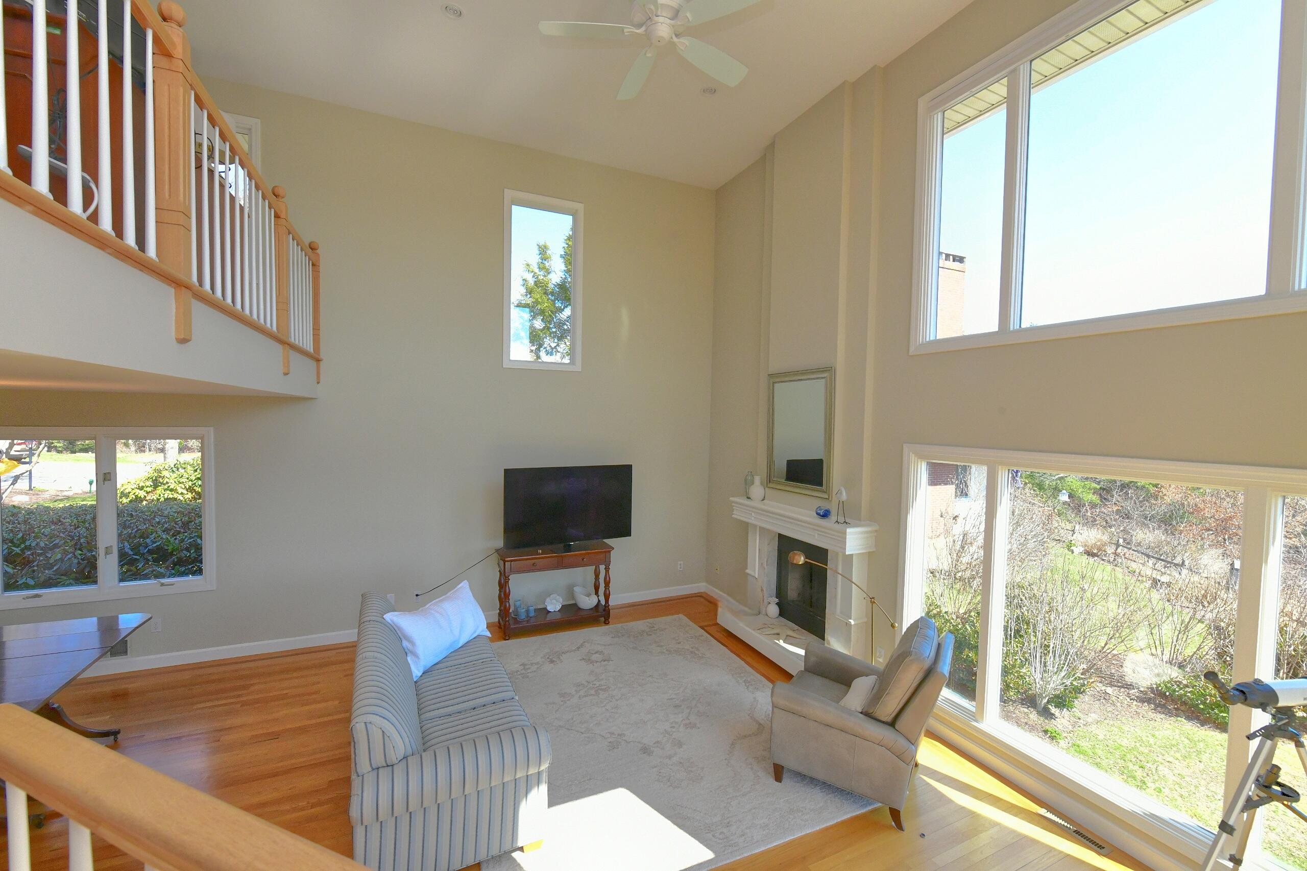 4 Bittersweet Lane, Unit 4G Buzzards Bay, MA 02532 - Photo 14 of 26 a living room with furniture a flat screen tv and a fireplace