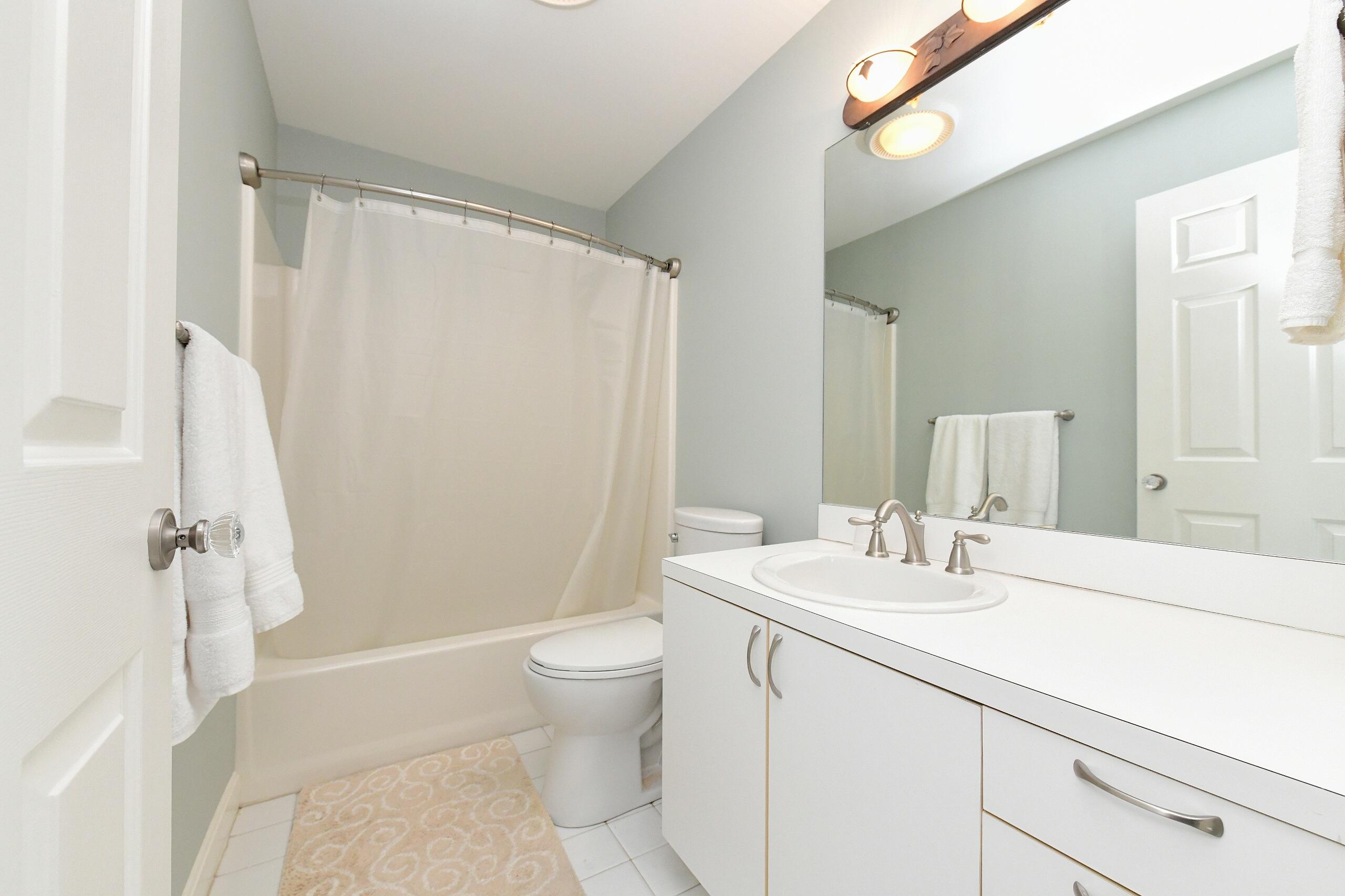 4 Bittersweet Lane, Unit 4G Buzzards Bay, MA 02532 - Photo 22 of 26 a bathroom with a sink a toilet and shower