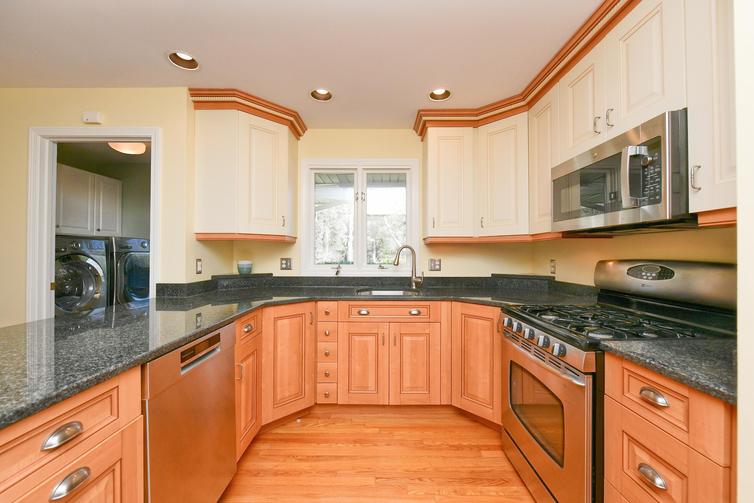 4 Bittersweet Lane, Unit 4G Buzzards Bay, MA 02532 - Photo 4 of 26 a large kitchen with stainless steel appliances granite countertop a sink and cabinets