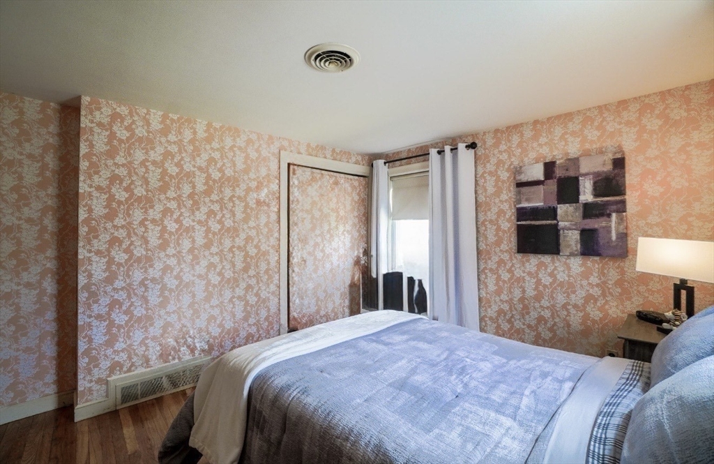 53 Yale Road Needham, MA 02494 - Photo 12 of 21 a bedroom with a bed and a lamp on dresser