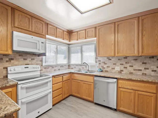 an empty room with a ceiling fan and window