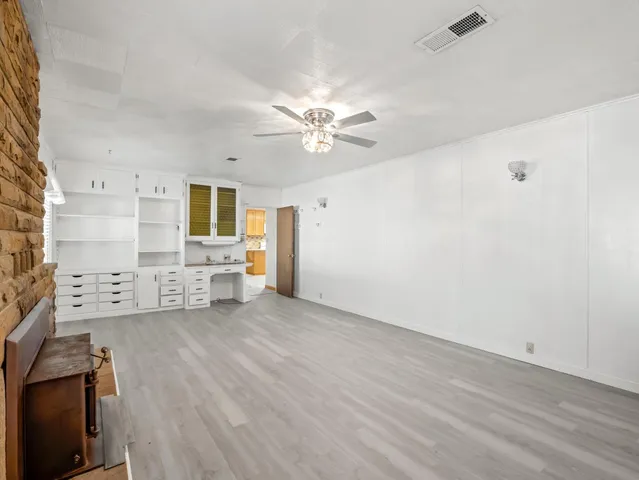 a bathroom with a granite countertop sink a mirror and a bathtub