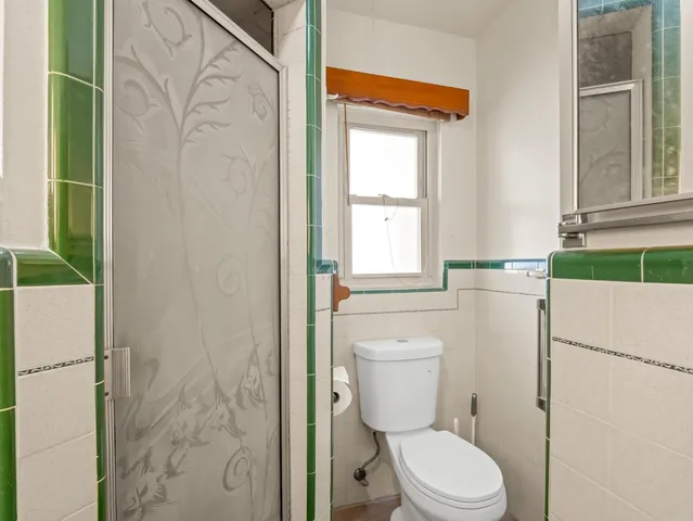 a view of an empty room with closet and a window