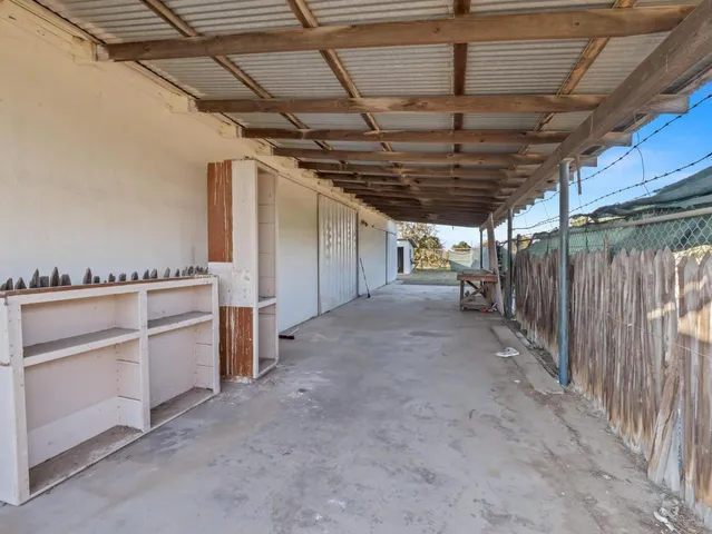 an aerial view of ocean and residential houses with outdoor space