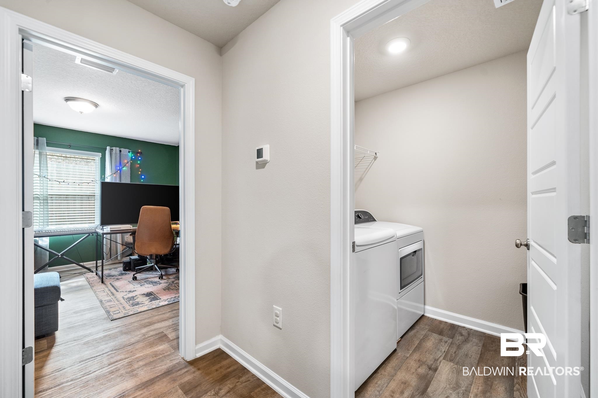 10516 Brodick Loop Daphne, AL 36527 - Photo 21 of 27 Laundry area featuring dark hardwood / wood-style flooring, a textured ceiling, and washer and dryer