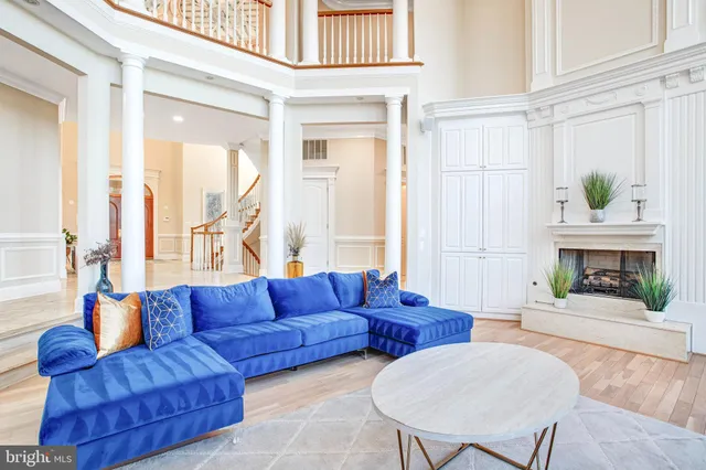 a spacious bedroom with two beds and potted plant next to a window