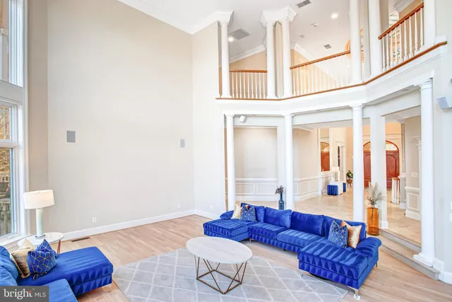 a bedroom with a bed lamp and a large window