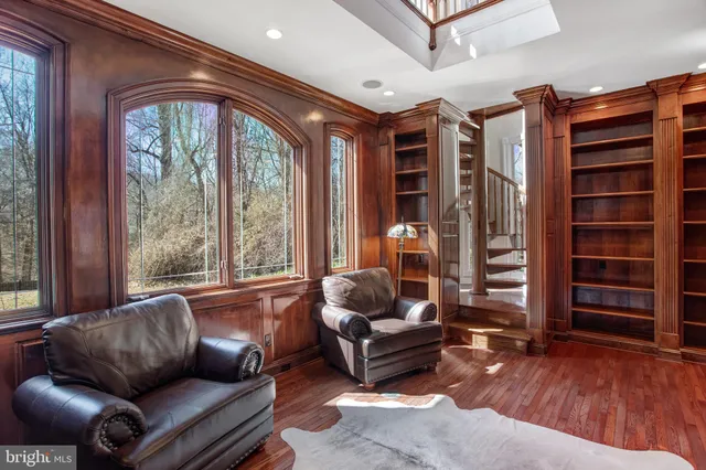 a view of a brick house with wooden fence