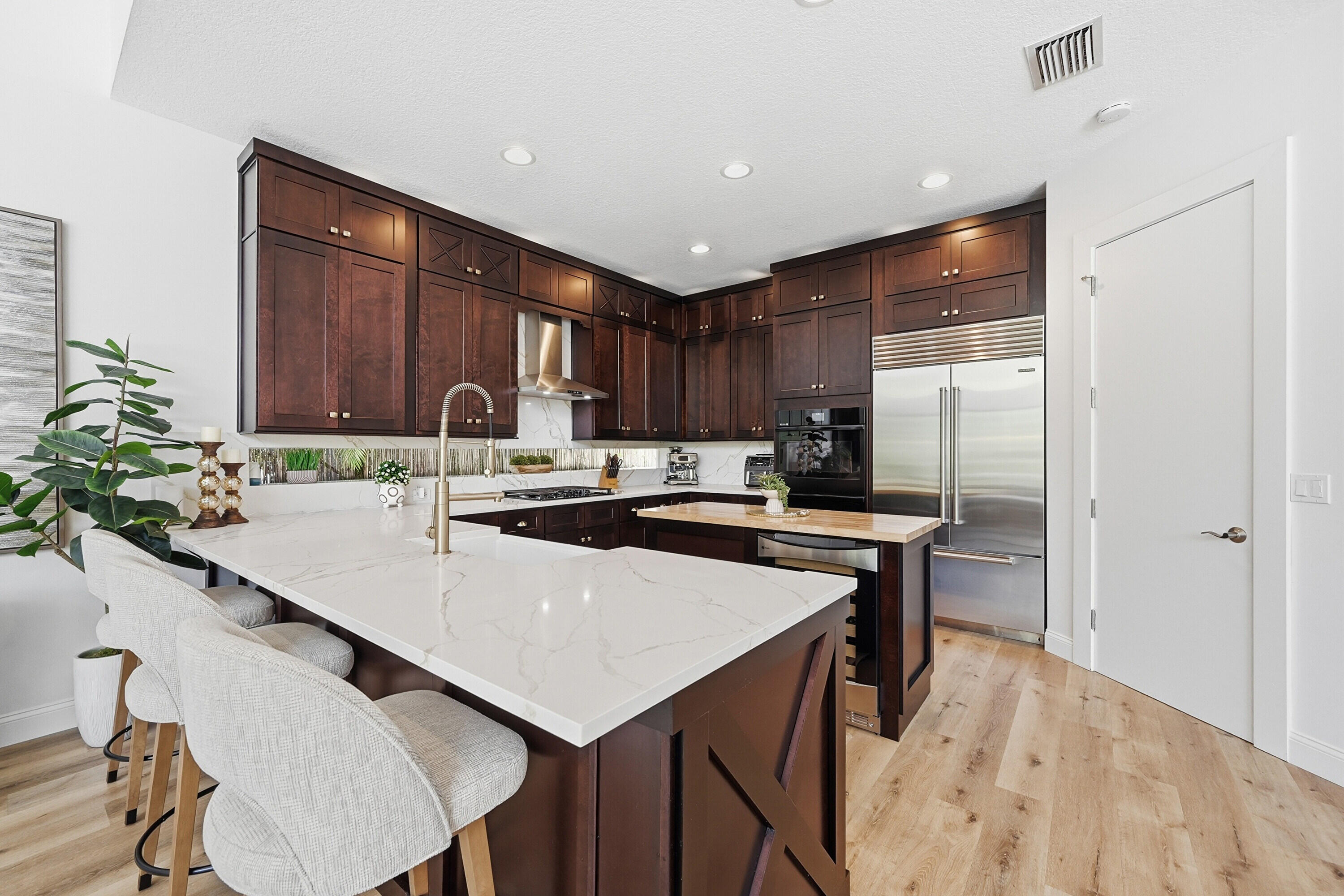 2399 Northwest 49th Lane Boca Raton, FL 33431 - Photo 17 of 75 a kitchen with stainless steel appliances a sink a stove a refrigerator and cabinets