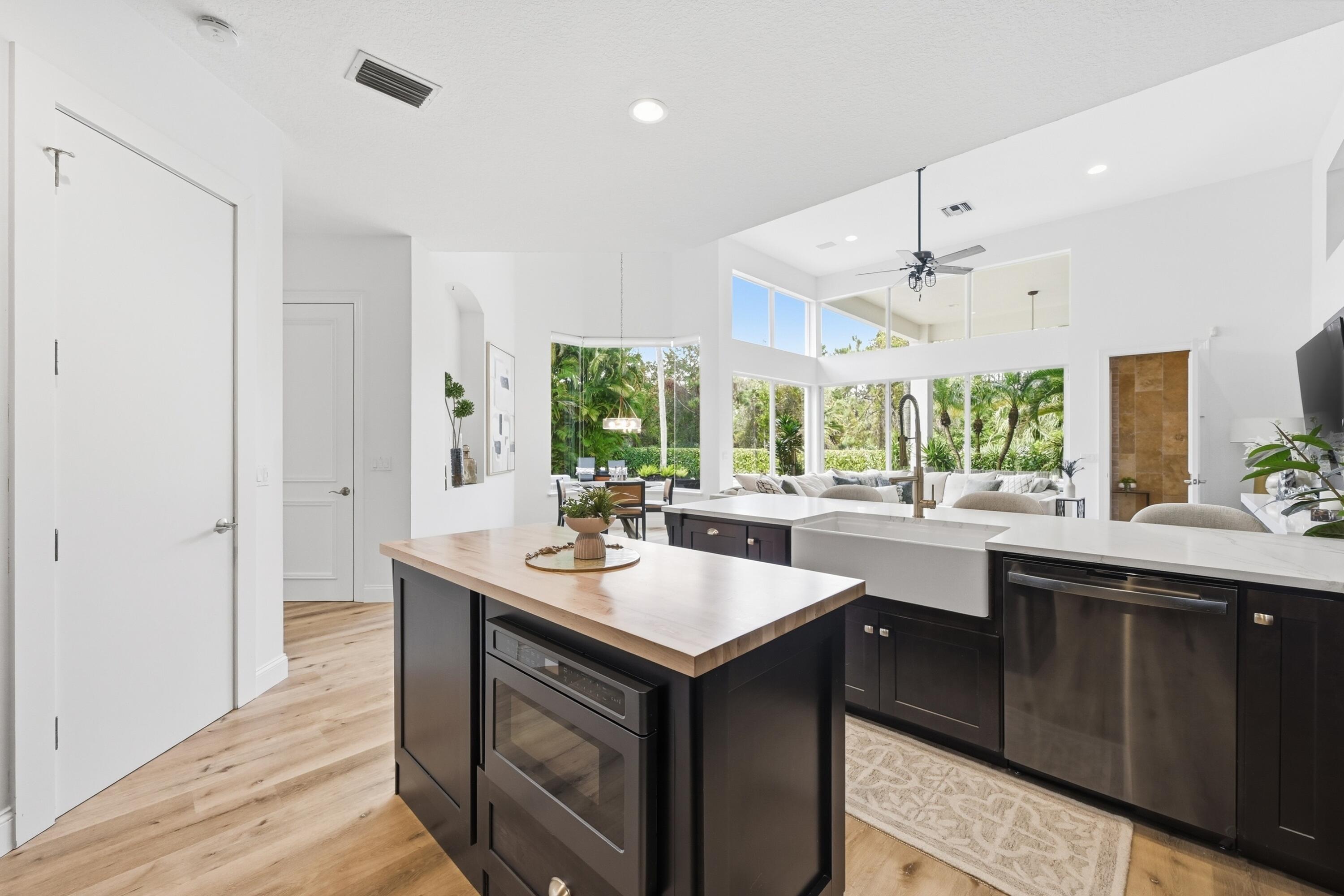 2399 Northwest 49th Lane Boca Raton, FL 33431 - Photo 19 of 75 a kitchen with a sink and wooden floor