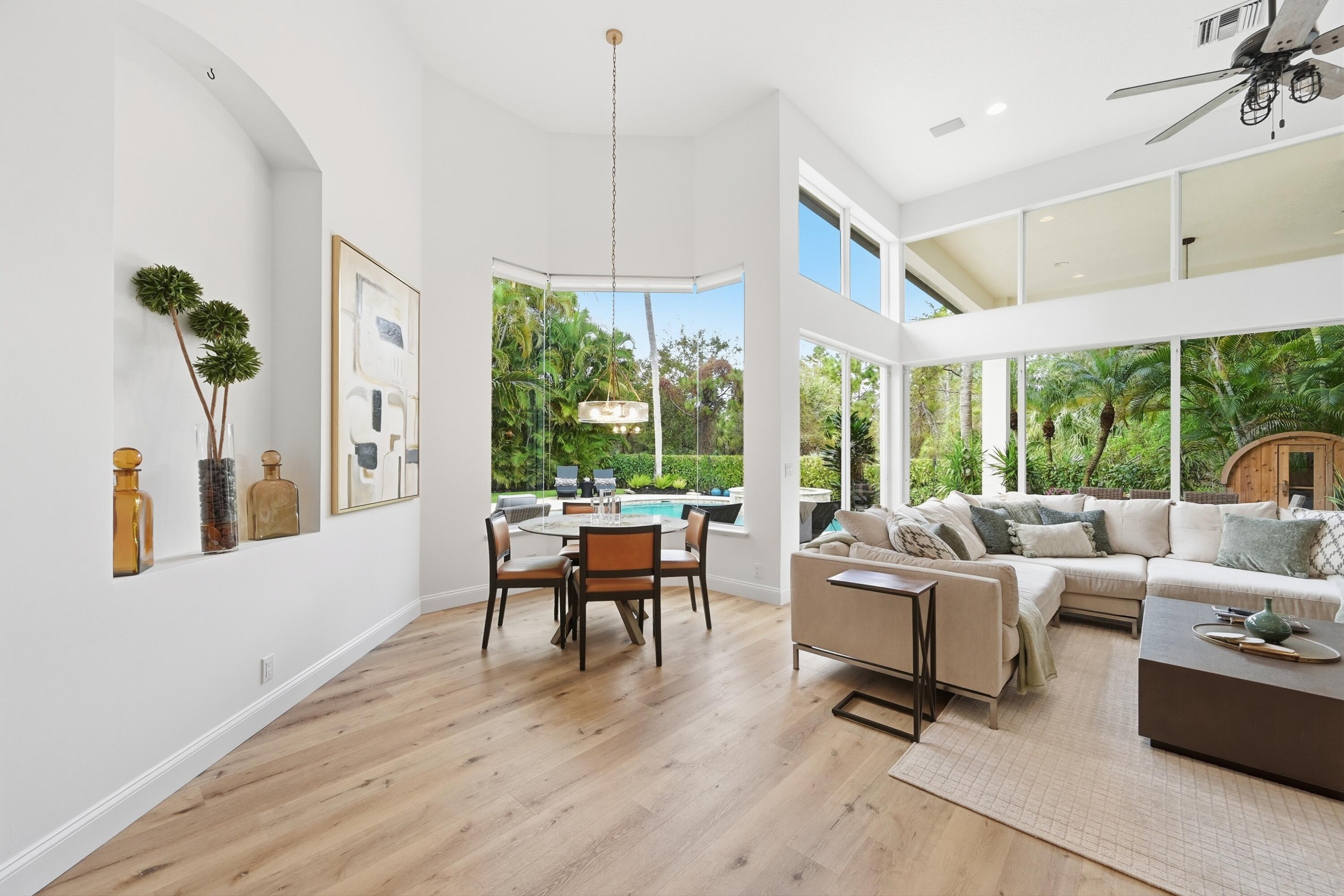 2399 Northwest 49th Lane Boca Raton, FL 33431 - Photo 21 of 75 a living room with furniture fireplace and large windows