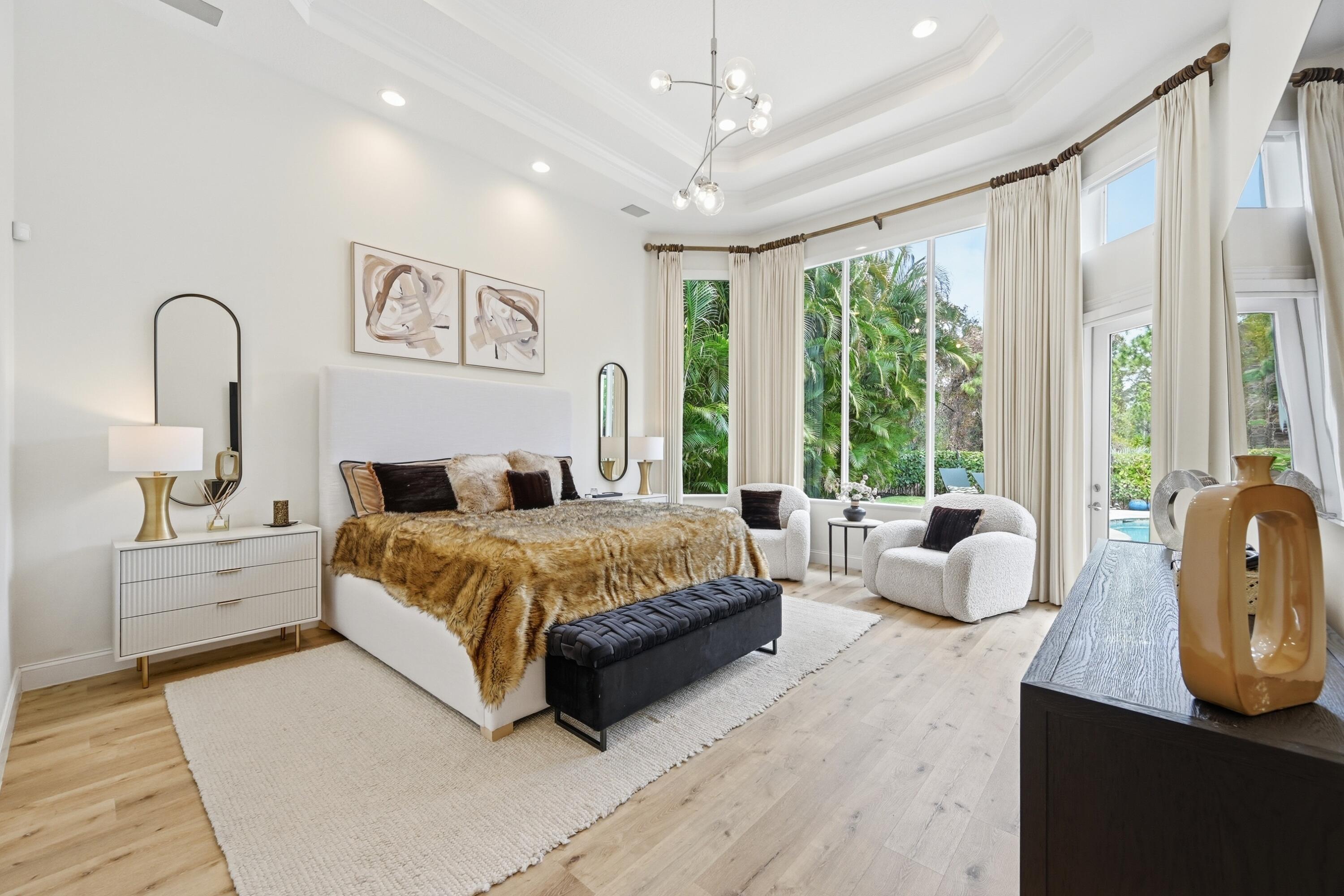 2399 Northwest 49th Lane Boca Raton, FL 33431 - Photo 27 of 75 a spacious bedroom with a large bed and a large window